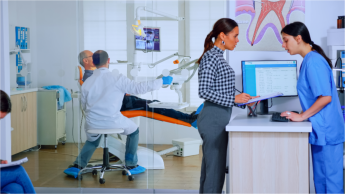 dental manager speaking to patient 