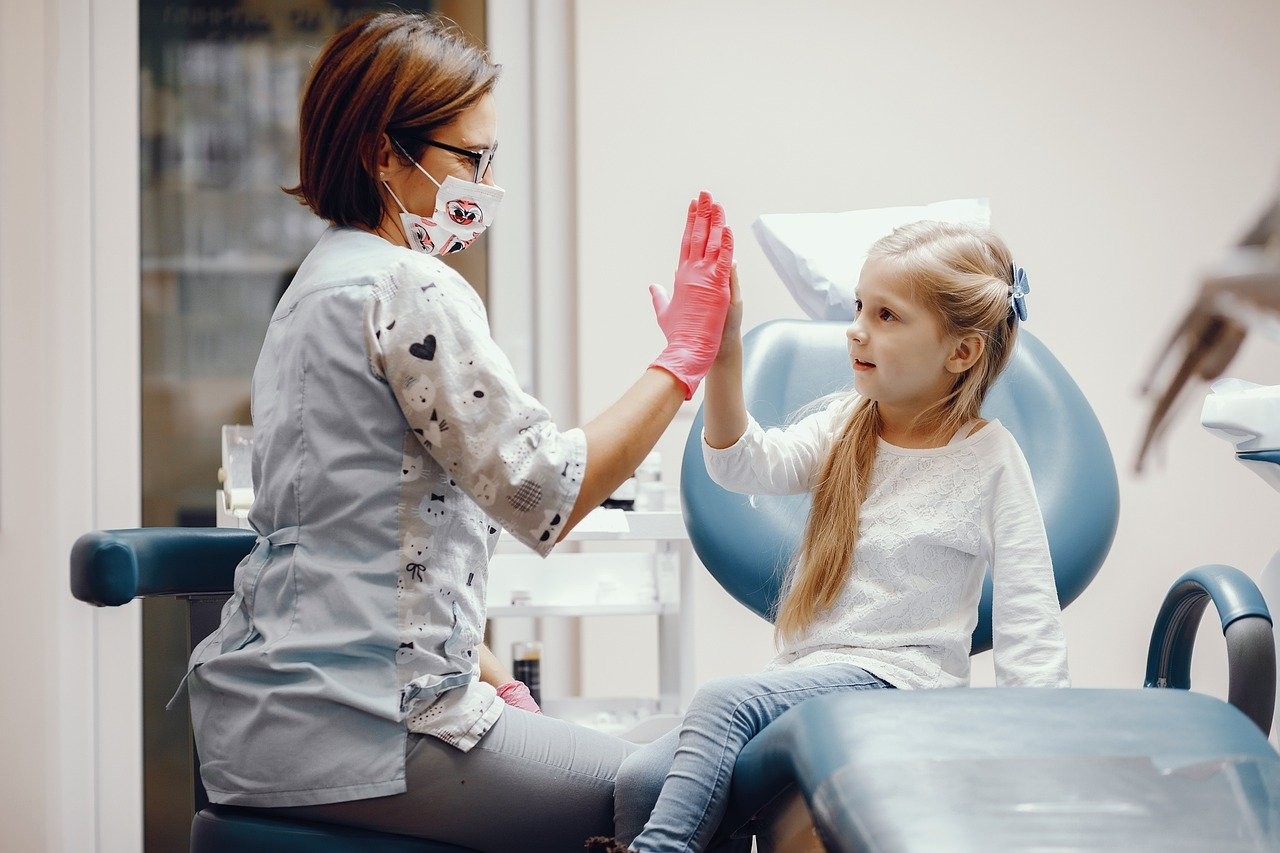 dentist and patient high fiving 