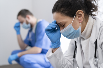 stressed healthcare workers in masks and gloves 
