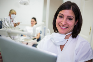 hygienist and dentist working with patient 