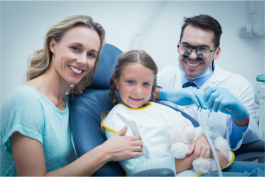 dentist and assistant with smiling patient 