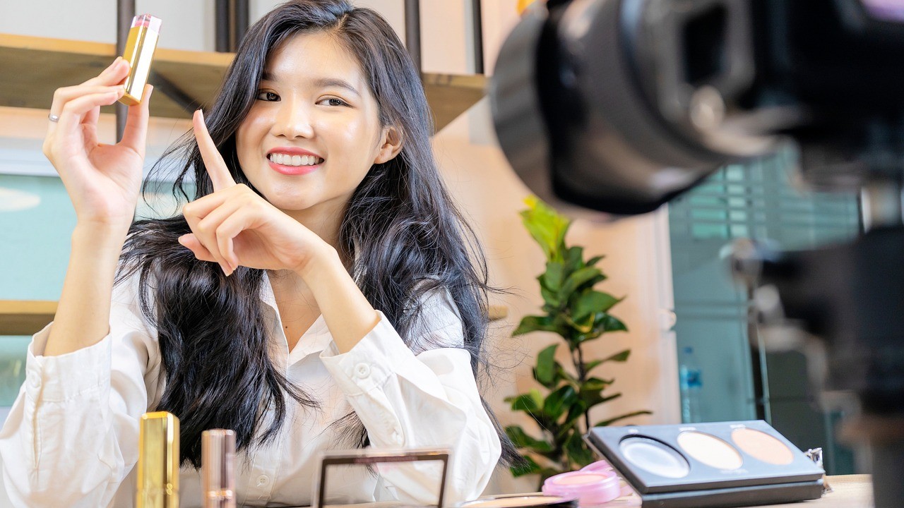 woman smiling while advertising makeup