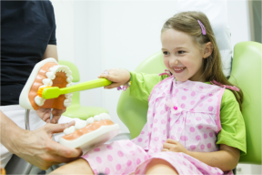 happy dental patient with teeth model 